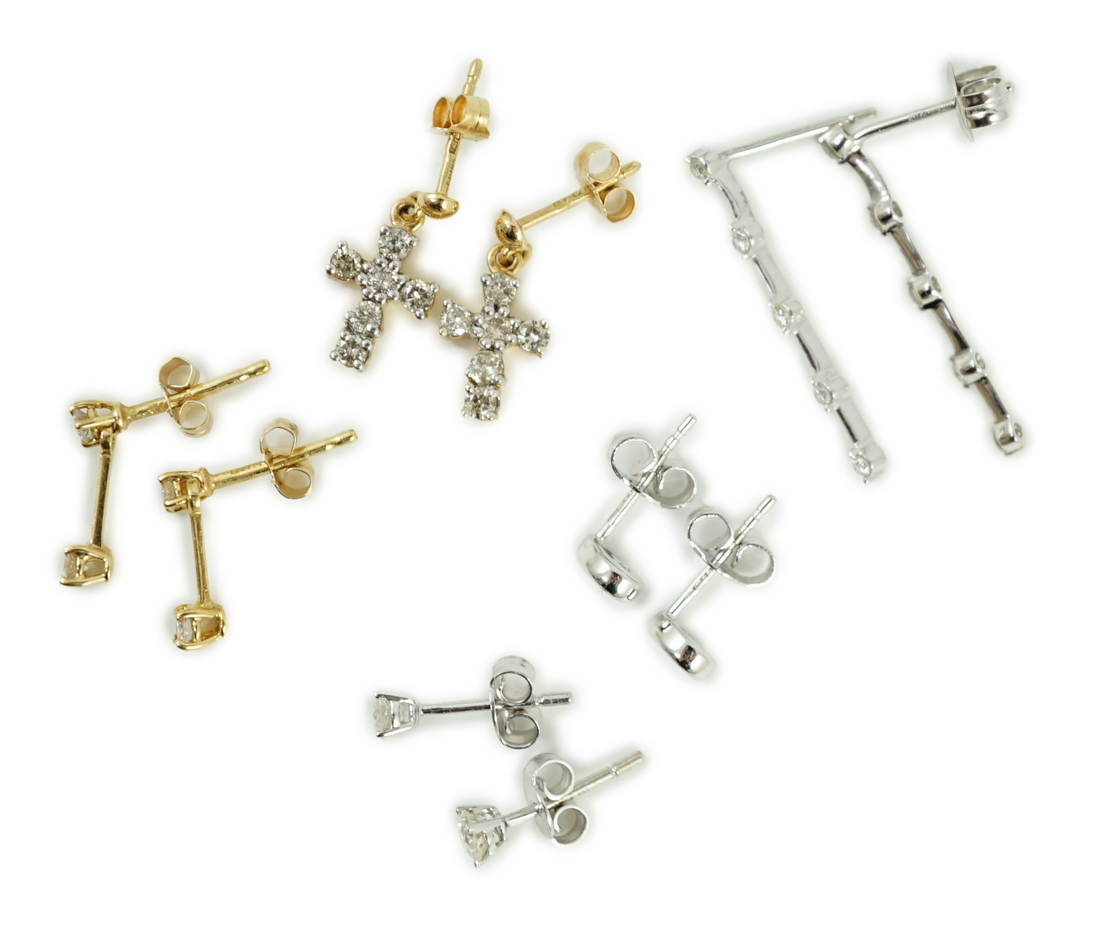 Three pairs of 18ct white gold and diamond set ear rings, including solitaire ear studs and two other pairs of 18ct gold and diamond set ear studs including cross, largest 24mm, gross weight 6.4 grams.